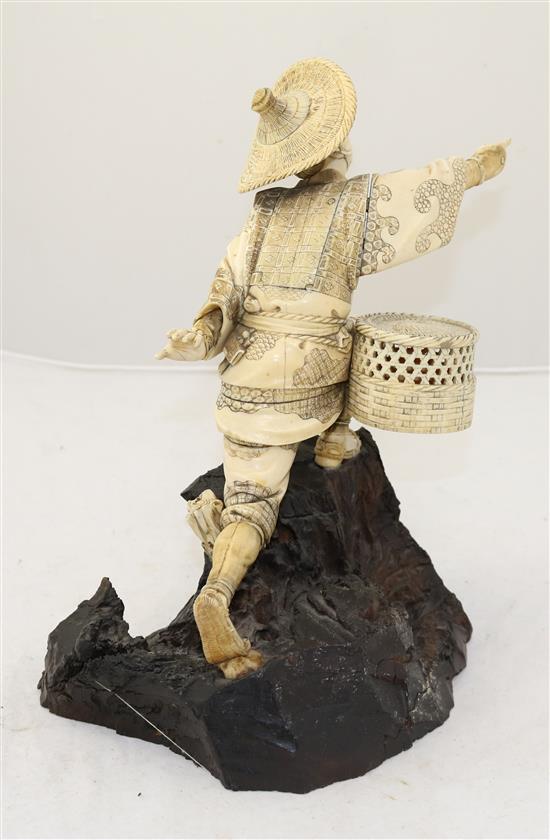 A Japanese sectional ivory figure of a fisherman, Meiji period, height 26.8cm, rod lacking